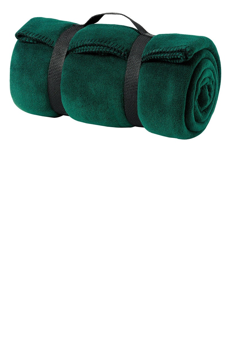 a rolled up green blanket on a white background