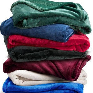 a pile of blankets stacked on top of each other