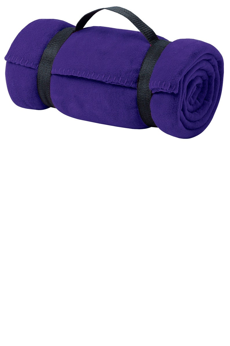 a rolled up purple towel on a white background