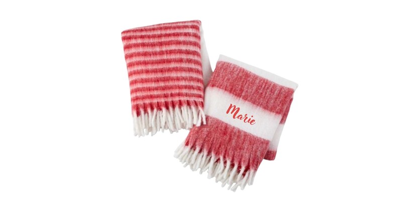 May include: Two red and white striped blankets with white fringe. One blanket has the name "Marie" embroidered on it.