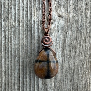 Chiastolite (Andalusite) for Protection and Rebirth with Copper Accents. Swirl to Signify Consciousness.