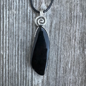 Natural Onyx for Strength, Vigor and Confidence. Spiral to Signify Consciousness.