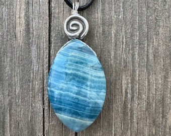 Blue Aragonite Pendant For Grounding and Past Life Regression with Black Cable. Swirl to Signify Consciousness.