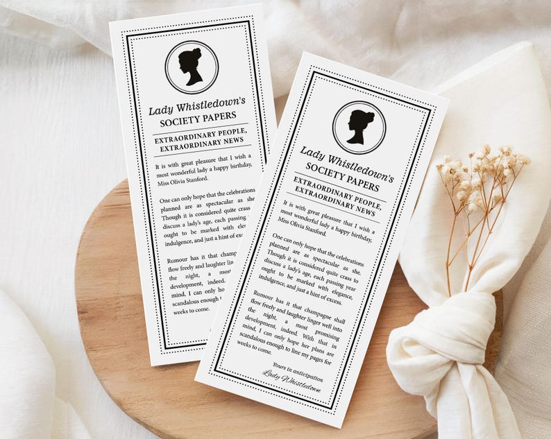 pretty black and white regency style society notice for a Birthday sitting on patterned white dinner plates next to a serviette with black bow