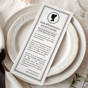 pretty black and white regency style society notice for a Birthday sitting on patterned white dinner plates next to a serviette with black bow