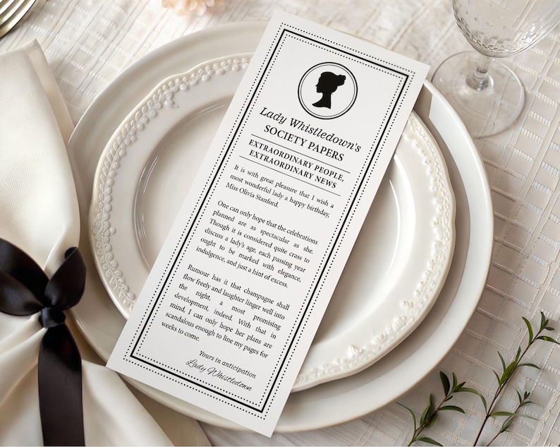 pretty black and white regency style society notice for a Birthday sitting on patterned white dinner plates next to a serviette with black bow