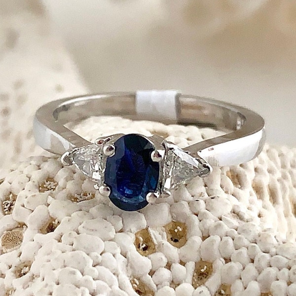 Sapphire Ring: Oval Blue Sapphire  set with 2 trillion cut diamonds set in platinum