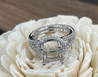 May include: A silver ring setting with a round center stone and a pave diamond band.