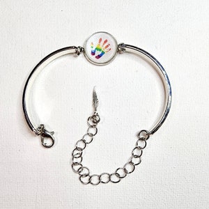 Sale was 22 Supernatural RAINBOW CASTIEL HANDPRINT bracelet with cute feather dangle. Silver toned.