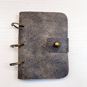 Supernatural Winchester Journal / notebook size SMOL (3 x 4) made from alt Dean Winchester jacket. Distressed black & tan. Black paper.