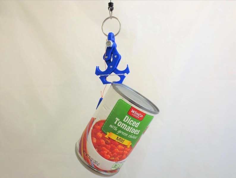 May include: A blue 3D-printed can lifter holds a can of diced tomatoes with green chiles. The can is silver with a green and white label. The can weighs 10 oz (283 g). The lifter is attached to a metal ring.