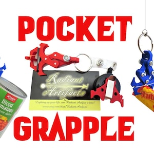 May include: The image showcases a red and blue pocket grapple, with the text "POCKET GRAPPLE" in red. The grapple is holding a can of diced tomatoes and a Starburst candy. A business card is also present.