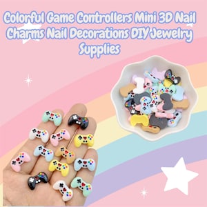 May include: Miniature, colorful game controller charms in various colors, including black, white, pink, yellow, and blue. The charms are displayed in a white bowl and held in a hand. Text at the top reads "Colorful Game Controllers Mini 3D Nail Charms Nail Decorations DIY Jewelry Supplies."