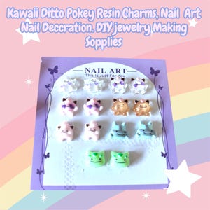 May include: A display of resin charms for nail art and jewelry making. The charms are in the shape of cartoon characters in various colors, including pink, brown, and green. The text "NAIL ART - This Is Just For You" is visible.