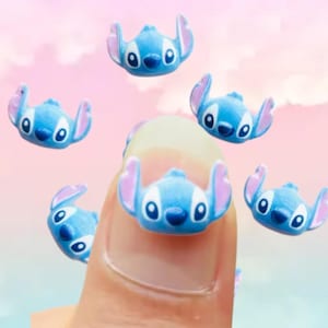 May include: A set of six blue and pink Stitch character charms. The charms are small and have a 3D design. They are perfect for adding a touch of Disney magic to your crafts.