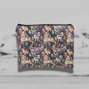 May include: A black zippered pouch with a colorful print of characters and masks from the Scream movie franchise.