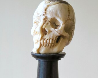 Human skull carving of deer antler