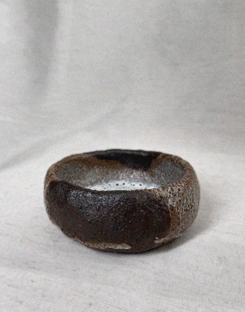Small earthy hand pinched Stoneware Bowl with Crater Surface from Shino Glaze Wabi Sabi Nature in Brown Pottery