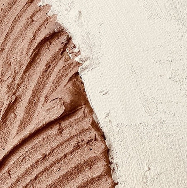 May include: Close-up of a textured surface with two distinct colors: a smooth, light beige area and a rough, brown area. The brown area has a swirling, wave-like pattern.