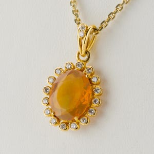 18k gold pendant with an opal and diamonds