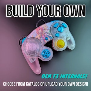 May include: A clear, customizable GameCube controller with a pink and blue anime character design. The controller has blue buttons and a yellow C-stick. The text "BUILD YOUR OWN" and "OEM T3 INTERNALS! CHOOSE FROM CATALOG OR UPLOAD YOUR OWN DESIGN!" is visible.