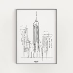 May include: Black and white line art print of the New York City skyline, featuring the Empire State Building. The print is framed in a black frame and has the text "NEW YORK" at the bottom.