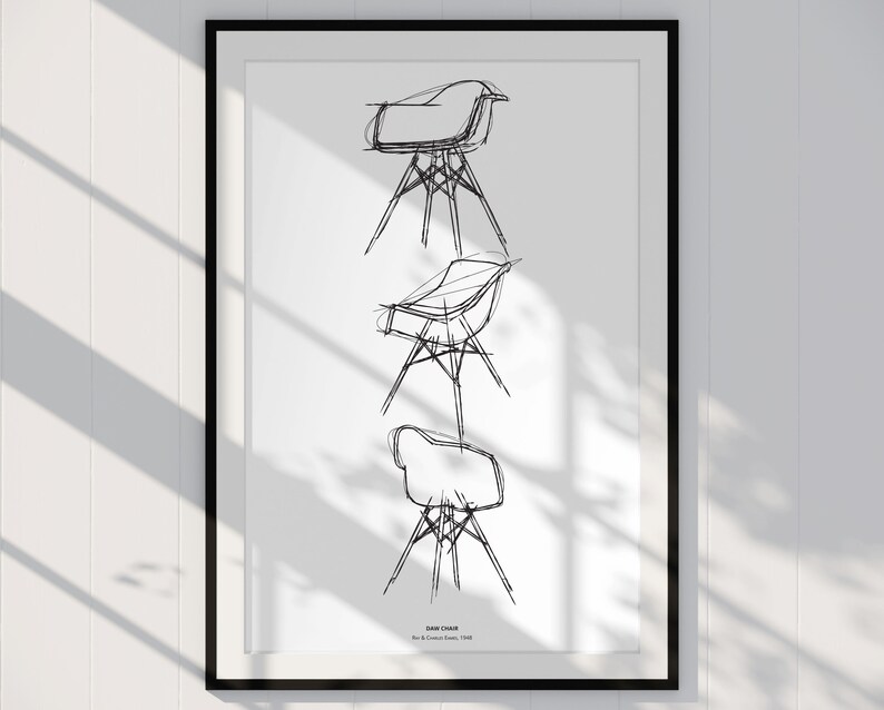 May include: A black and white line drawing of three different chair designs. The drawing is framed in a black frame and is hanging on a white wall.