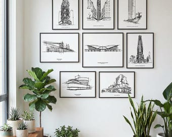 May include: Nine framed black and white architectural sketches of buildings are displayed on a white wall. The sketches are in a minimalist style, showcasing various building designs. The room is decorated with plants and a wooden cabinet.