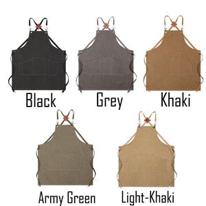 May include: Five aprons in different colours: black, grey, khaki, army green, and light khaki. Each apron has two large front pockets, adjustable straps, and a leather accent at the neck. The colour name is printed below each apron.