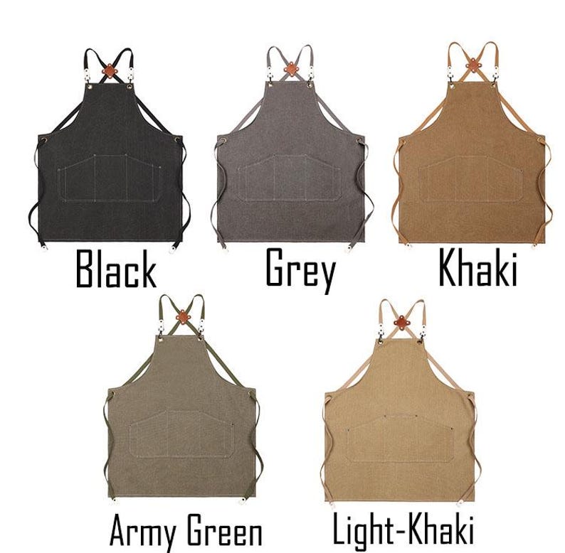 May include: Five aprons in different colours: black, grey, khaki, army green, and light khaki. Each apron has two large front pockets, adjustable straps, and a leather accent at the neck. The colour name is printed below each apron.