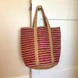 Jute basket bag, handmade woven tote bag made from eco friendly jute with cerise, deep pink striped with natural, plain jute and plain jute handles.