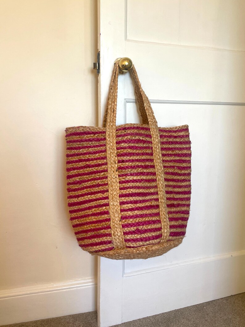 Jute basket bag, handmade woven tote bag made from eco friendly jute with cerise, deep pink striped with natural, plain jute and plain jute handles.