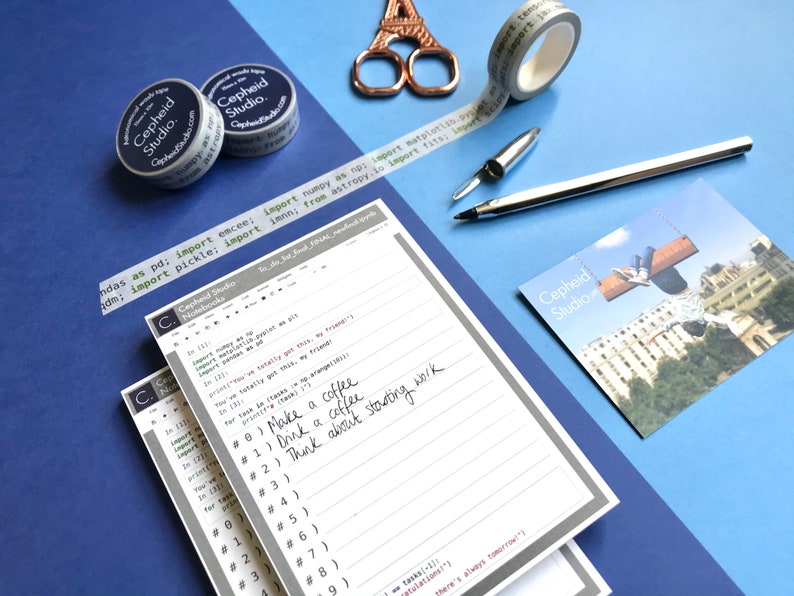 May include: A stack of gray and white lined notebooks with a gray border. The top notebook has handwritten notes in black ink that say "Make a coffee", "Drink a coffee", and "Think about starting work". The notebooks have the text "Cepheid Studio" printed on the cover.