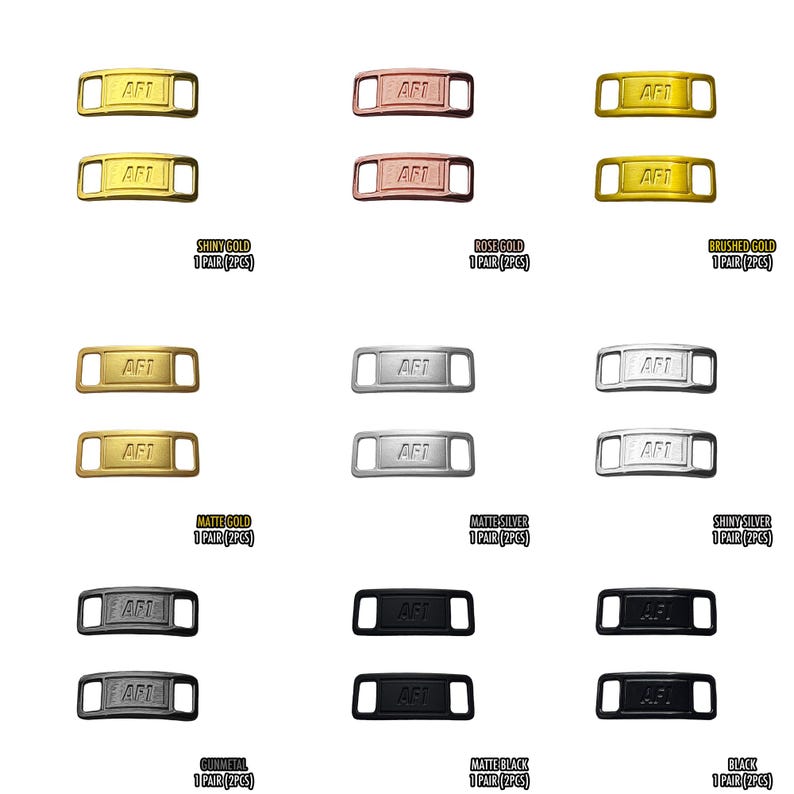 May include: A collection of shoe lace tags in various metallic finishes, including shiny gold, rose gold, brushed gold, matte gold, matte silver, shiny silver, gunmetal, matte black, and black. Each tag has the letters "AFT" engraved.