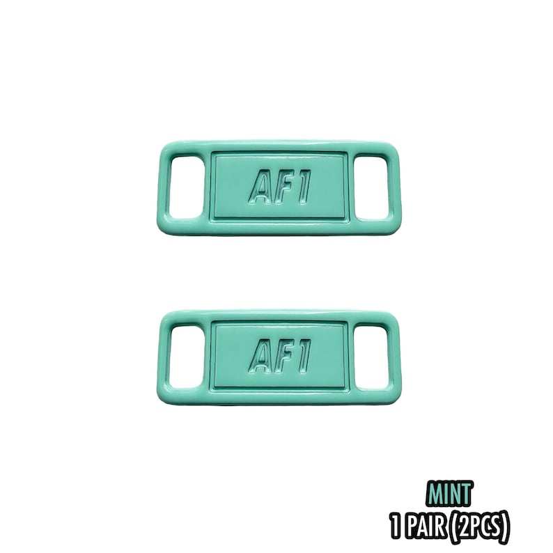 May include: Two mint-colored shoe tags with the text "AF1" embossed on each. The tags are rectangular with rounded corners and two rectangular holes on each side. The bottom right corner of the image has the word "MINT" and "1 PAIR (2PCS)".
