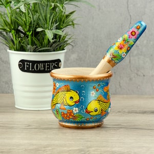 A unique set of mortar and pestle,made of beech and painted with Petrykivka painting|The mortar and pestle set is made as a real work of art
