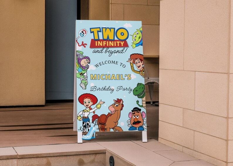 May include: A light blue, A-frame sign with the text "TWO INFINITY and beyond!" and "Welcome to MICHAEL'S Birthday Party". The sign features cartoon characters from the Toy Story movie.