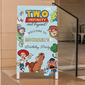 May include: A light blue sign with the text "TWO INFINITY and beyond!" and "WELCOME TO MICHAEL'S Birthday Party" featuring cartoon characters from Toy Story. The sign is placed on a concrete surface.