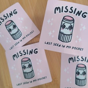 May include: Four pink stickers with a cartoon lip balm with a sad face and the text "MISSING LAST SEEN IN MY POCKET".