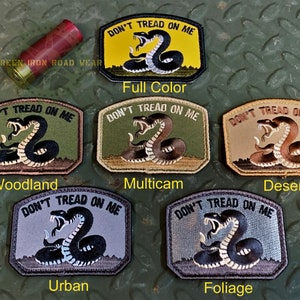 May include: Six different color variations of a "Don't Tread On Me" patch featuring a coiled rattlesnake with the text "Don't Tread On Me" above it. The colors are: Full Color, Woodland, Multicam, Desert, Urban, and Foliage.