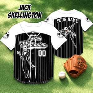 May include: White and black baseball jersey featuring Jack Skellington from The Nightmare Before Christmas. The jersey has vertical black stripes, the character's image, and the text "Jack Skellington" and "00". A baseball glove and ball are also in the image.