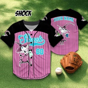 May include: Pink and black baseball jersey with vertical stripes, featuring the word "Shock" in teal script and a cartoon character graphic. The jersey has the number "00" and a baseball glove and ball are in the image.
