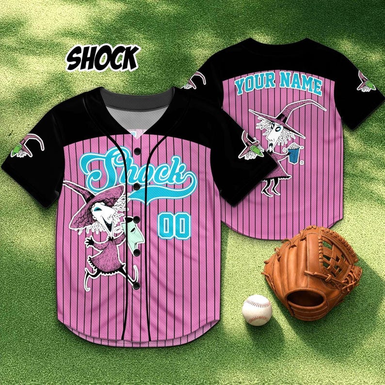 May include: Pink and black baseball jersey with vertical stripes, featuring the word "Shock" in teal script and a cartoon character graphic. The jersey has the number "00" and a baseball glove and ball are in the image.