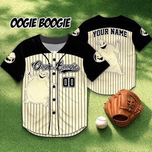 May include: Baseball jersey with a cream and black color scheme, featuring the text "Oogie Boogie" and a cartoon character graphic. The jersey has vertical stripes, the number "00", and a baseball glove and ball are also visible.
