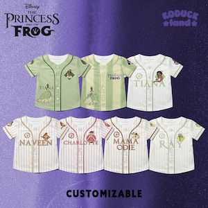 May include: Baseball jerseys featuring characters from Disney's "The Princess and the Frog." The jerseys are white, green, and cream-colored with character names and illustrations. The text "CUSTOMIZABLE" is at the bottom. The Disney and Koduck Land logos are at the top.
