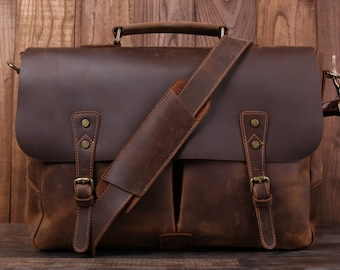 May include: A brown leather messenger bag with a long adjustable shoulder strap and two buckles on the front. The bag has a distressed look and is made of high-quality leather.