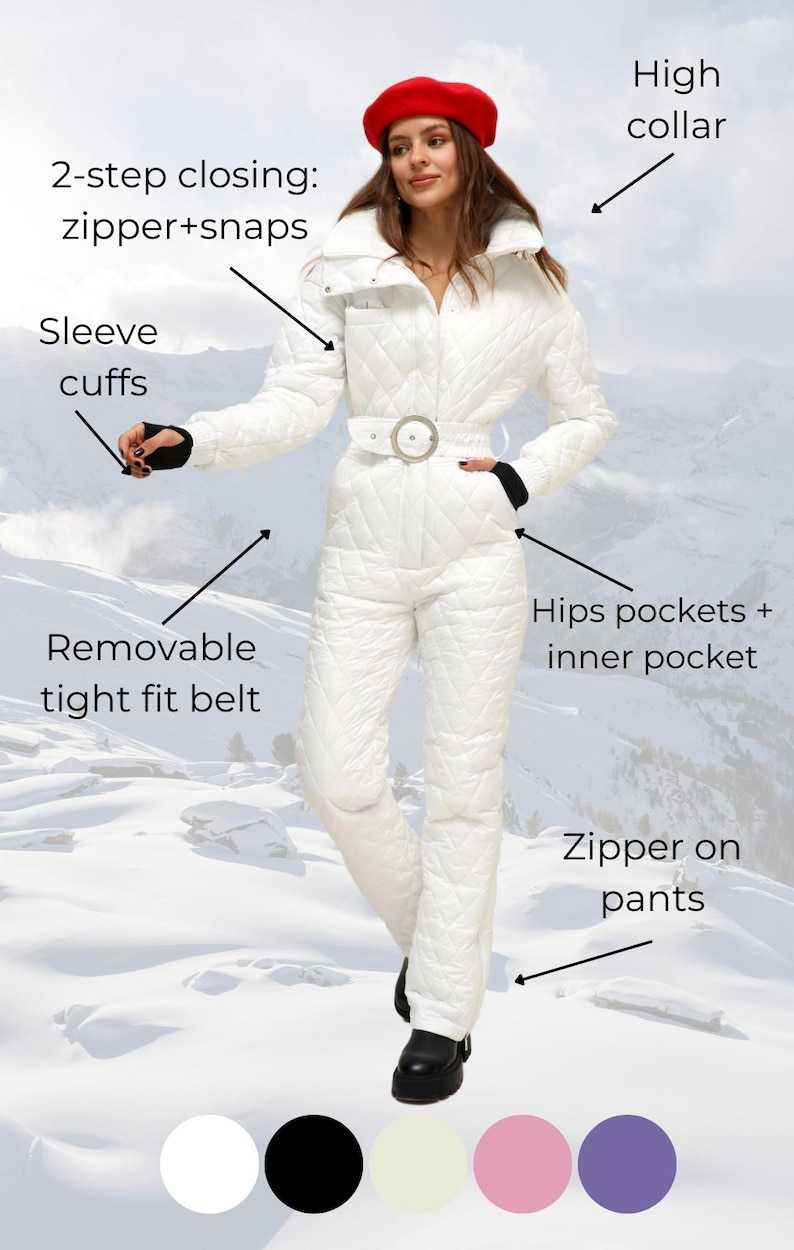 May include: White quilted ski jumpsuit with a high collar, a removable belt, and zippered pockets. The jumpsuit has a 2-step closing system with a zipper and snaps. The model is wearing a red beret.