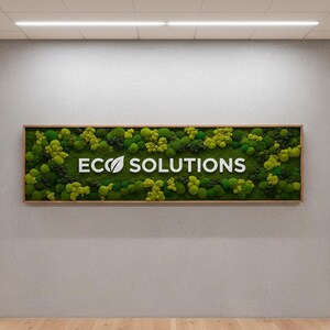 May include: A rectangular wall sign featuring a dense arrangement of preserved green moss in various shades and textures. The white text ECO SOLUTIONS is centered on the moss, with a leaf icon replacing the letter O in ECO.