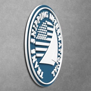 May include: An oval-shaped wall sign featuring a deep blue background with a white border. The sign displays a white graphic of a sailboat and the text TRANS SHIPPING INTERNATIONAL in raised white lettering encircling the central design.
