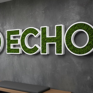 May include: A wall-mounted sign featuring the word ECHO in large, white, three-dimensional letters filled with preserved green moss. To the left of the text is a circular emblem containing a white cross shape with a vertical sound wave graphic.